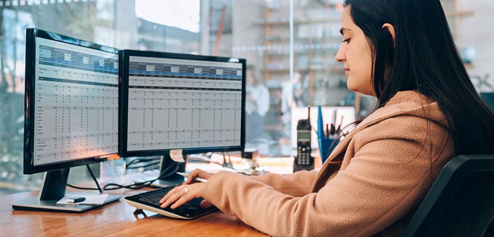 Professional analyzing data on screens