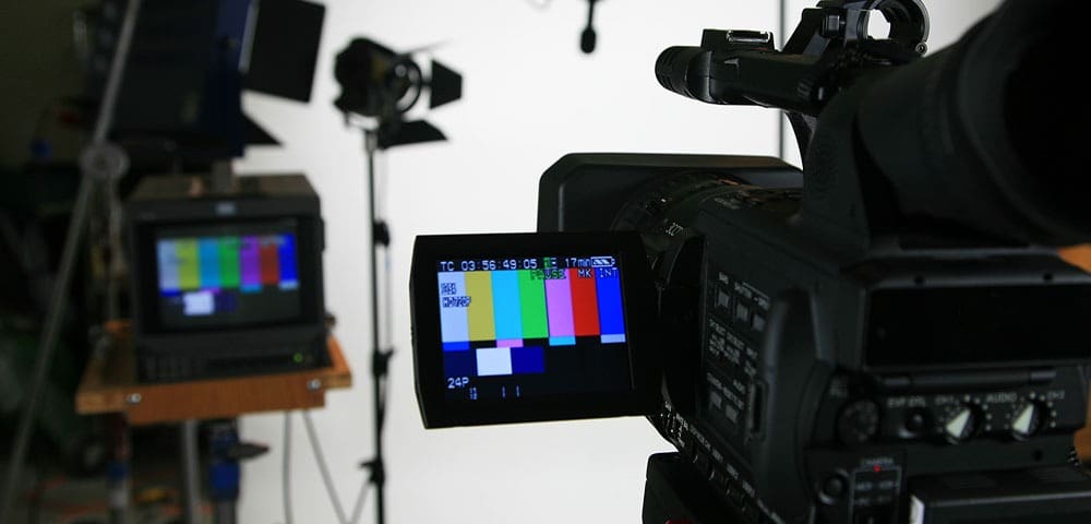 Camera recording in studio with color bars