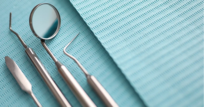 Dental tools on a blue surface