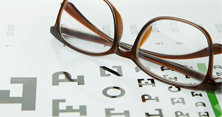 Eyeglasses resting on vision test